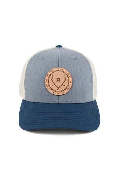 REVOLVR simplify trucker cap in grey, birch and navy with leather logo patch on front and adjustable snapback front view