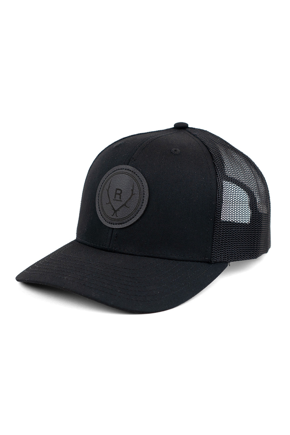 REVOLVR simplify trucker cap in black with leather logo patch on front and adjustable snapback profile view