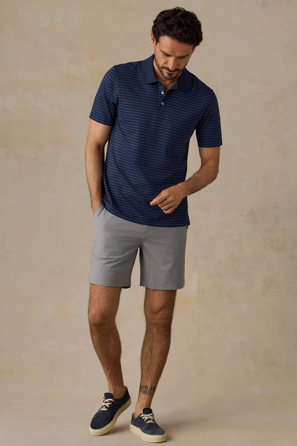 Faherty Movement Pique Polo in Twilight Stream Stripe — Lifestyle view