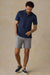 Faherty Movement Pique Polo in Twilight Stream Stripe — Lifestyle view