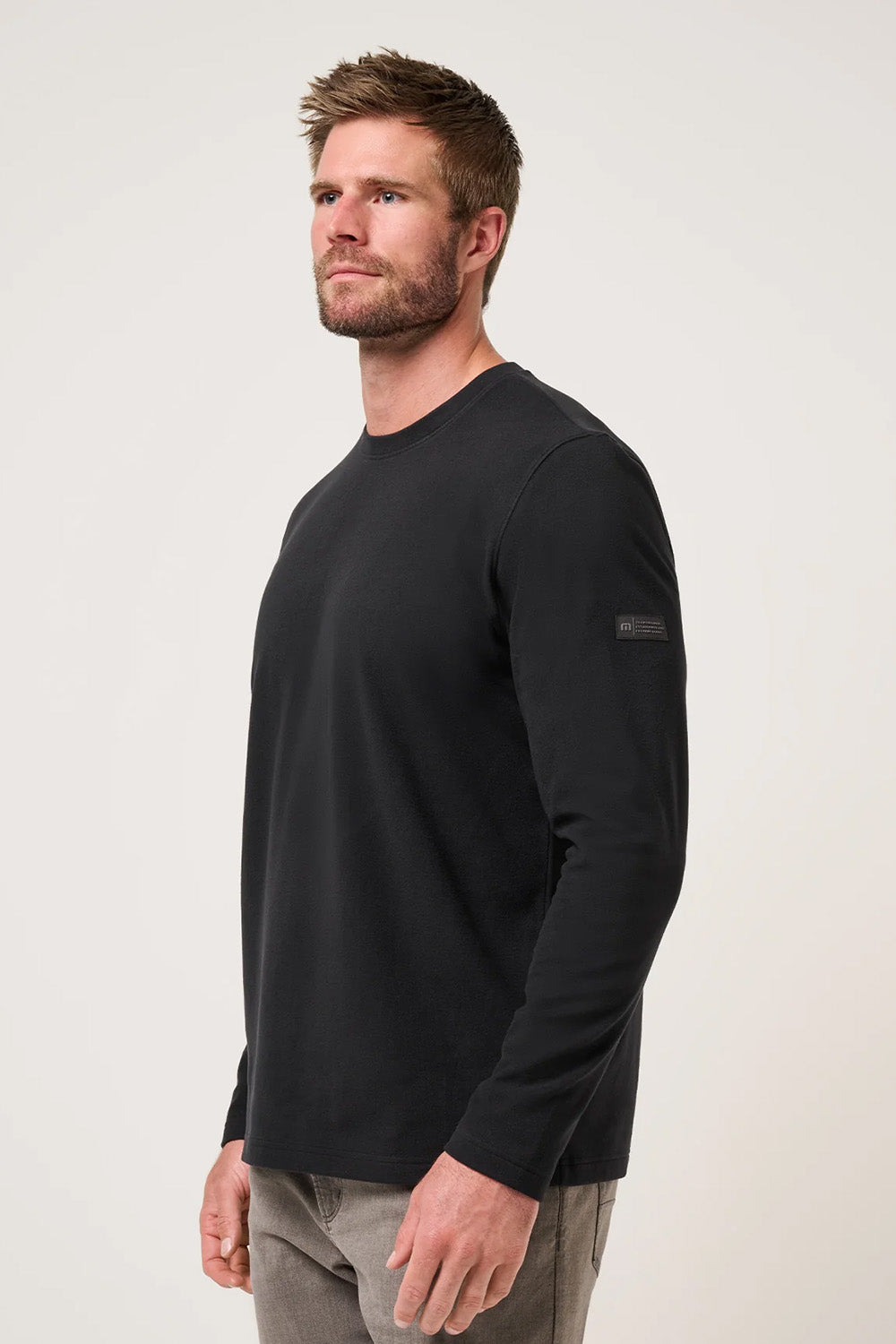 Travis Mathew Peak Fleece Crew in Black — Profile view