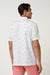 travis mathew on a mission polo in white back view