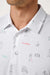 travis mathew on a mission polo in white detail view