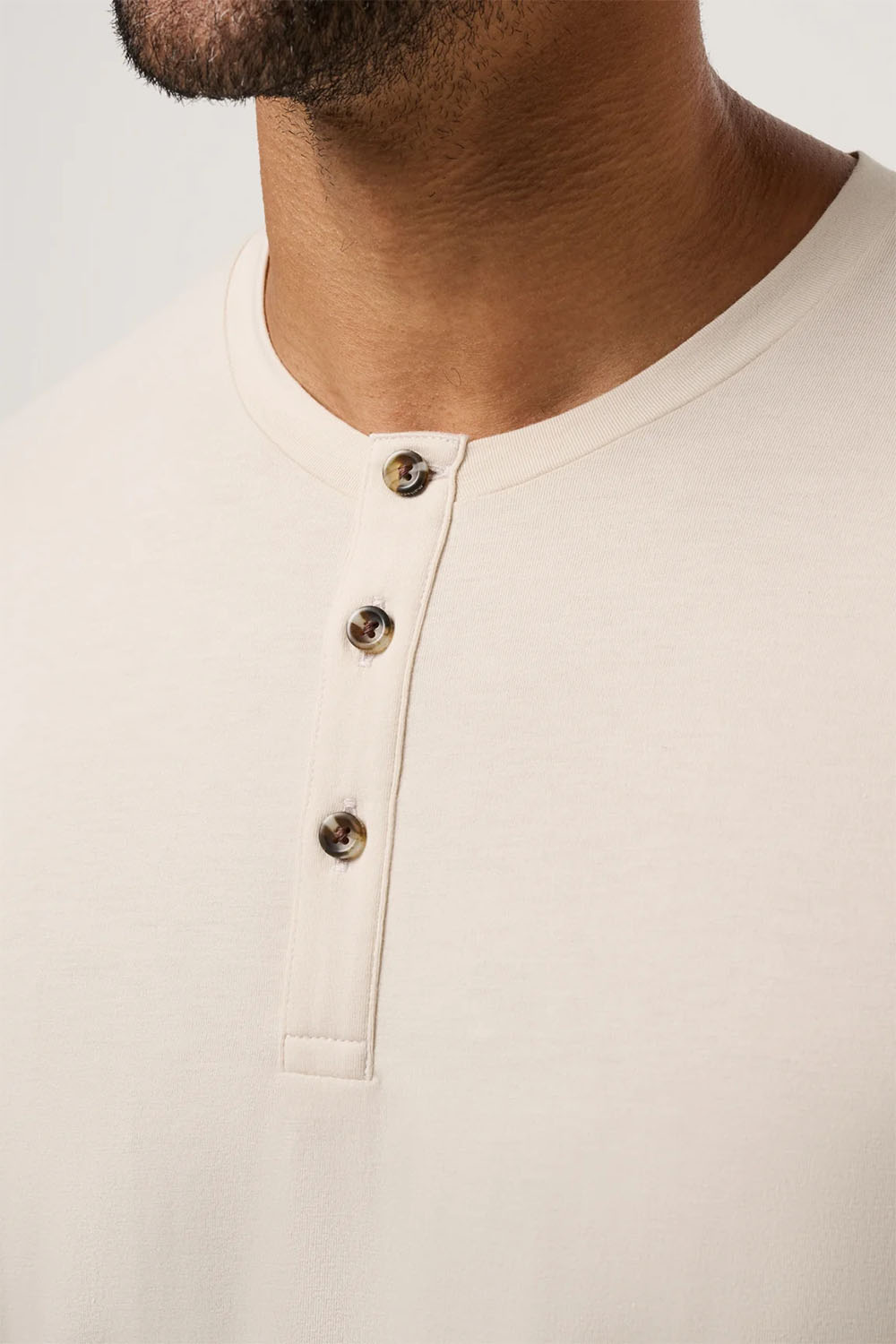 travis mathew cloud henley tee italian sand detail