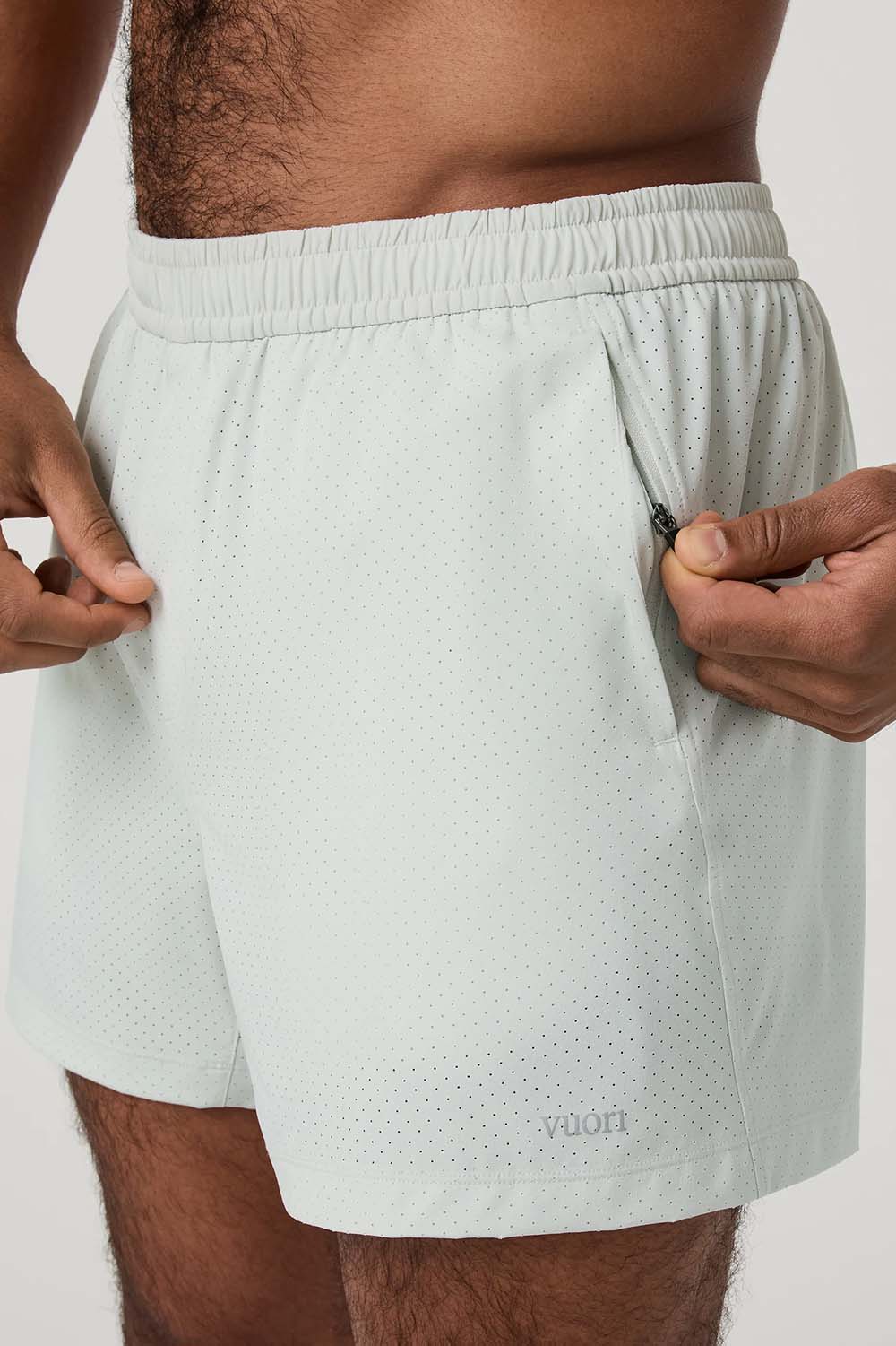 Vuori Kore Breathe Short 7" in Breeze — Zip pocket detail view
