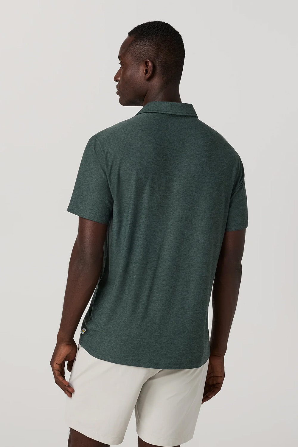 Vuori Strato Tech Polo in Hemlock Heather — Back view