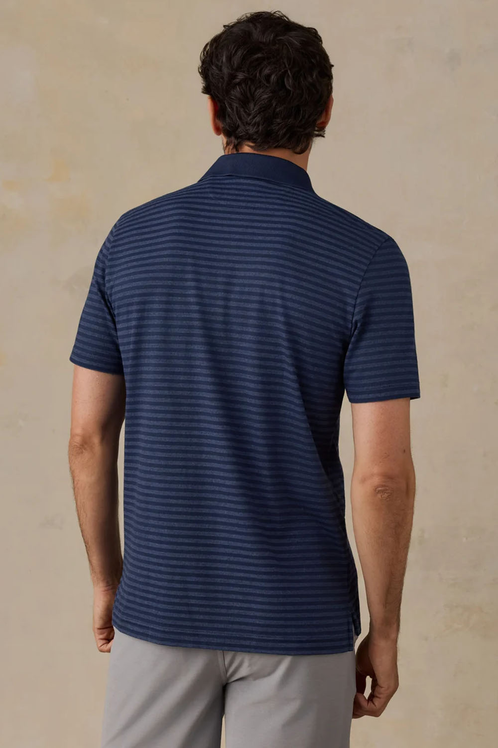 Faherty Movement Pique Polo in Twilight Stream Stripe — Back view